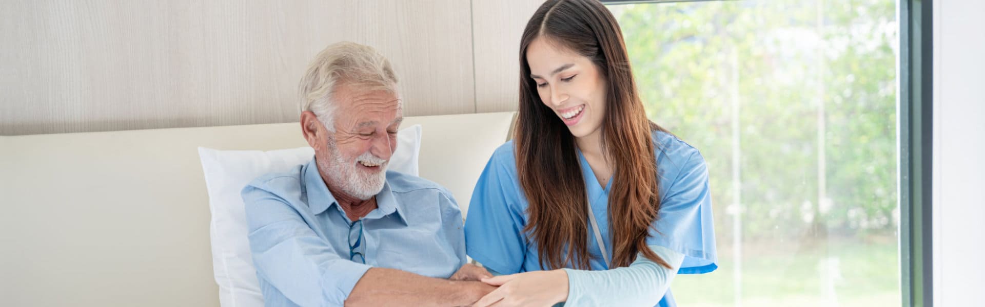 happy man in bed with his caregiver